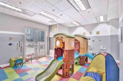 a childrens play room with a slide and a playground at Curated Sky Abode Ocean and City views, Sleeps 6 in Miami