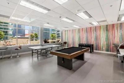 a billiard room with two tables and a pool table at Magnificent Ocean Sky Residence in Miami