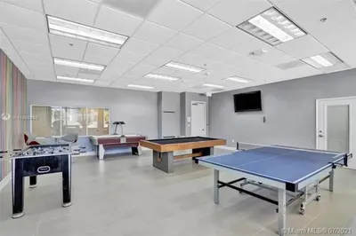 a room with two ping pong tables and a tv at Magnificent Ocean Sky Residence in Miami