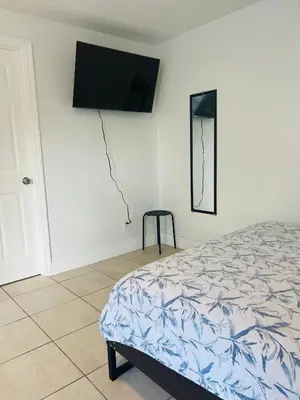 a bedroom with a bed and a tv on the wall at Sunshine Cove in Lake Forest