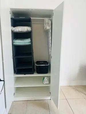 a walk in closet with white shelves at Sunshine Cove in Lake Forest