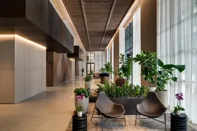 a lobby with chairs and potted plants at Sky-High Views Pool and Fitness Center Access in Miami