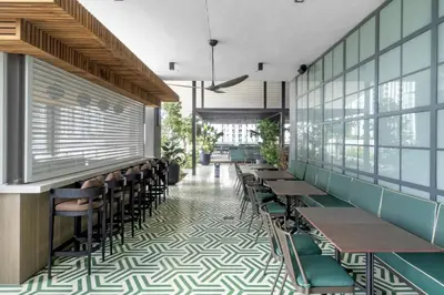 a restaurant with tables and chairs in a room at Sky-High Views Pool and Fitness Center Access in Miami