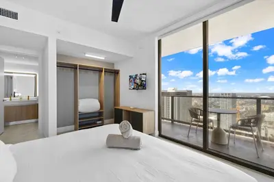 a bedroom with a bed and a large window at Luxury 45th-Floor Condo with Stunning City Views in Miami