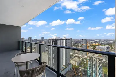 a balcony with a table and chairs and a view of the city at Luxury 45th-Floor Condo with Stunning City Views in Miami