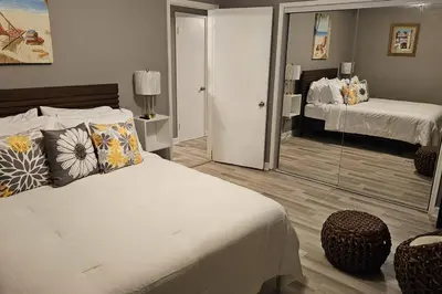 a bedroom with a bed and a mirror at Wynwood Miami Family Oasis in Miami