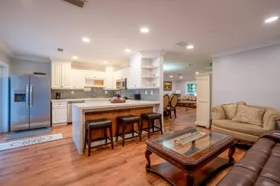 a kitchen and living room with a couch and a table at House Genesis in Homestead