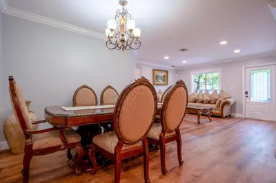 a dining room with a table and chairs at House Genesis in Homestead