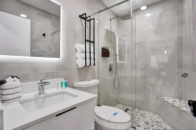 a bathroom with a toilet and a sink and a shower at Hollywood Lux Retreat in Hollywood