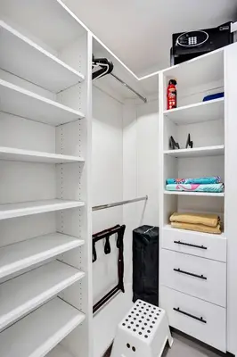 a white walk in closet with white shelves at Hollywood Lux Retreat in Hollywood