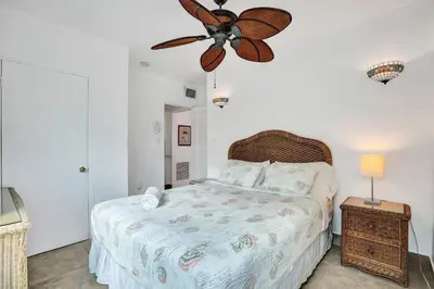 a bedroom with a bed and a ceiling fan at Sunset Oceanfront Retreat in Hollywood