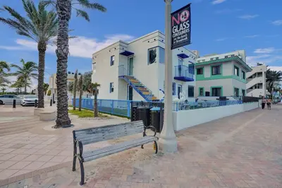 a bench on a sidewalk in front of some buildings at Sunset Oceanfront Retreat in Hollywood