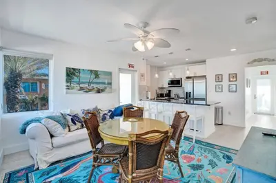 a living room with a table and a couch at Sunset Oceanfront Villa in Hollywood
