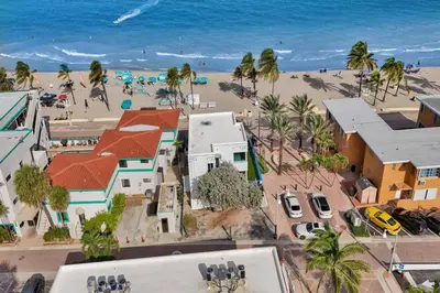 an aerial view of a beach with palm trees and buildings at Sunset Oceanfront Villa in Hollywood