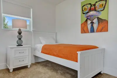a bedroom with a bed and a painting on the wall at Coastal Breeze Retreat in Pembroke Pines
