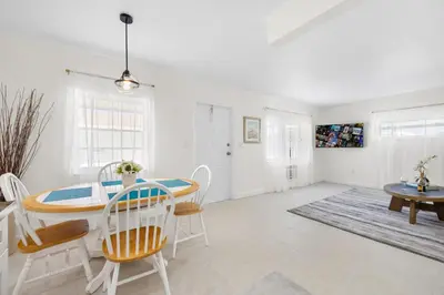a dining room with a table and chairs at Sunset Inn - Hallandale Beach in Hallandale Beach