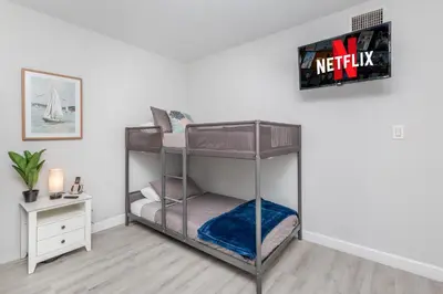a bedroom with two bunk beds in a room at Beachside Parking - Las Olas, Airport, Port Evg in Fort Lauderdale