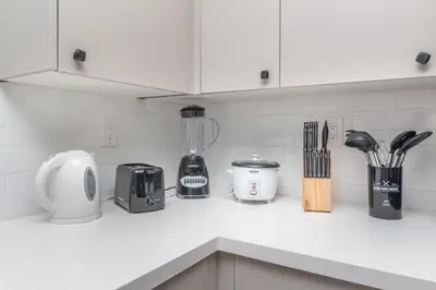 a kitchen counter with appliances on a white counter top at Beachside Parking - Las Olas, Airport, Port Evg in Fort Lauderdale
