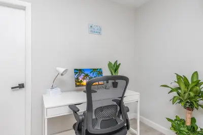 a desk with a chair and a computer monitor at Beachside Parking - Las Olas, Airport, Port Evg in Fort Lauderdale