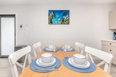 a dining room table with blue and white dishes on it at Beachside Parking - Las Olas, Airport, Port Evg in Fort Lauderdale