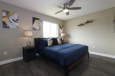 a bedroom with a bed and a ceiling fan at Walk to Stadium - 3BR King Bed Haven - Parking in Miami Gardens