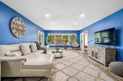 a living room with a couch and a tv at 3-Bedroom Villa with Heated Pool and Tropical Yard in Hollywood Lakes in Hollywood