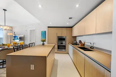 a kitchen with wooden cabinets and a counter top at On the Beach, Ocean and City Views 17 Zen at LYFE Resort in Hollywood