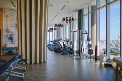 a gym with a row of treadmills and machines at On the Beach, Ocean and City Views 17 Zen at LYFE Resort in Hollywood