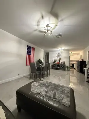 a living room with a couch in the middle of it at HOSTEL Star in Hallandale Beach