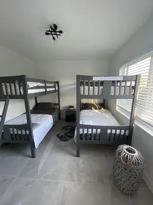 a bedroom with two bunk beds in a room at HOSTEL Star in Hallandale Beach