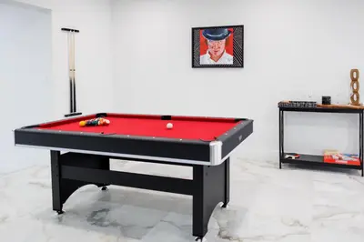 a black and red pool table in a room at Plumeria Housing in Fort Lauderdale