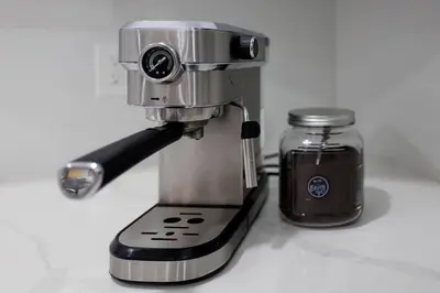 a mixer sitting on a counter next to a jar at Plumeria Housing in Fort Lauderdale