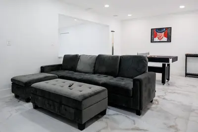a living room with a couch and a piano at Plumeria Housing in Fort Lauderdale