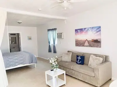 a living room with a couch and a bed at Coastal Cabana in Hollywood