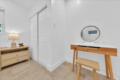 a dressing room with a desk and a mirror at Sunny Days Getaway, 5BD Heated Pool Family Home! in Fort Lauderdale