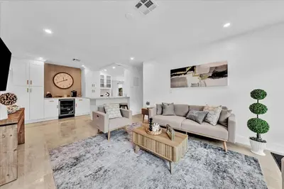 a living room with a couch and a table at Sunny Days Getaway, 5BD Heated Pool Family Home! in Fort Lauderdale