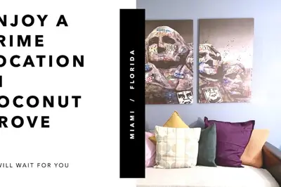 a room with a bed and a picture of a football player at GroveO1 10 min from the beach in Miami