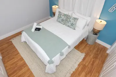 a small bedroom with a bed with a phone on it at Casa Bora Bora - Fun in Miami - Big Pool - Fit 12 in Miami