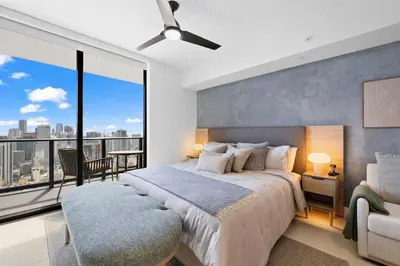 a bedroom with a large bed and a large window at On 47th Floor! Apartment With Top Amenities in Miami