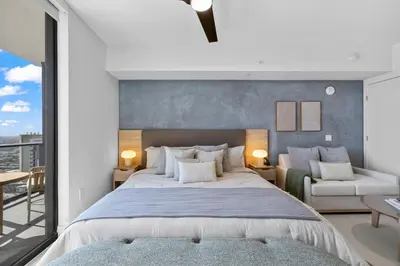 a bedroom with a large bed and a balcony at On 47th Floor! Apartment With Top Amenities in Miami