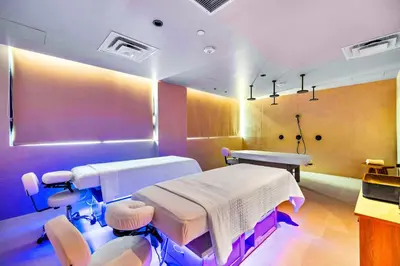 a hospital room with two beds and chairs at On 47th Floor! Apartment With Top Amenities in Miami