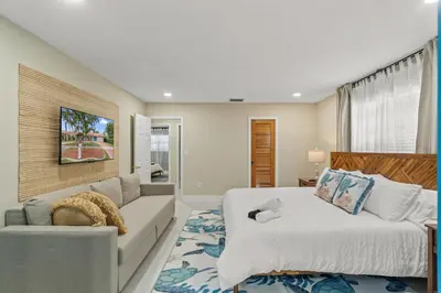 a bedroom with a bed and a couch at Casa Maldivas - Blue Oasis - Heated Pool in Tamiami