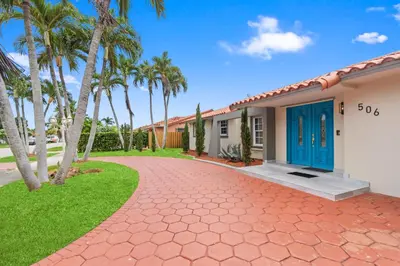a house with palm trees and a driveway at Casa Maldivas - Blue Oasis - Heated Pool in Tamiami