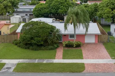 a house with a palm tree in a yard at Casa Mexican home - Big Pool - Hot Tub - FITS 12 in Miami