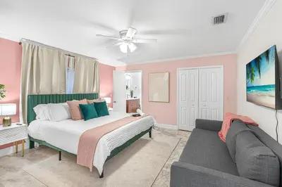 a bedroom with a bed and a couch at Casa Praga - Big pool & BBQ - Miami Fun in Tamiami