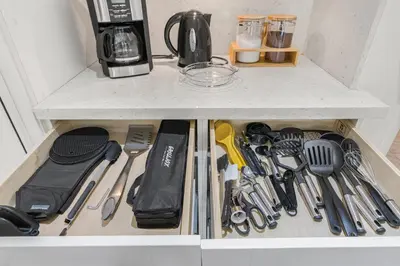 a drawer filled with kitchen utensils on a counter at Casa Praga - Big pool & BBQ - Miami Fun in Tamiami