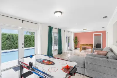 a living room with a ping pong table in it at Casa Praga - Big pool & BBQ - Miami Fun in Tamiami