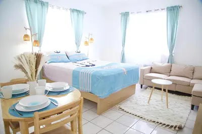 a bedroom with a bed and a table and a couch at Miami New Beach Stay 3 min to Ocean in Miami Beach