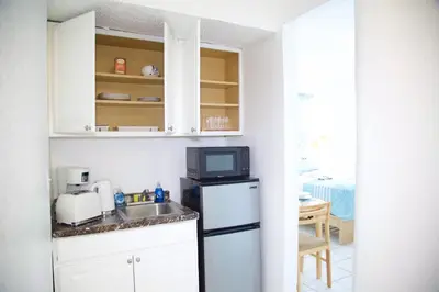 a kitchen with a sink and a microwave at Miami New Beach Stay 3 min to Ocean in Miami Beach