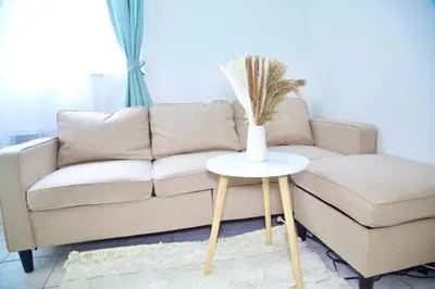 a living room with a couch and a vase on a table at Miami New Beach Stay 3 min to Ocean in Miami Beach